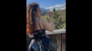 Young student shows off her charms against the backdrop of mountains