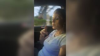 Pretty cougar smoking cigarettes while in car