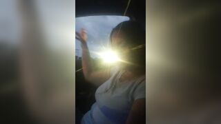 Pretty cougar smoking cigarettes while in car