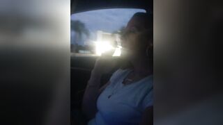 Pretty cougar smoking cigarettes while in car