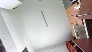 Sexy mom prepares breakfast naked in the kitchen.