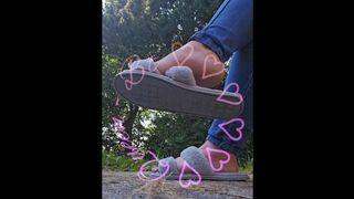 Dangling my house slippers on my toes.
